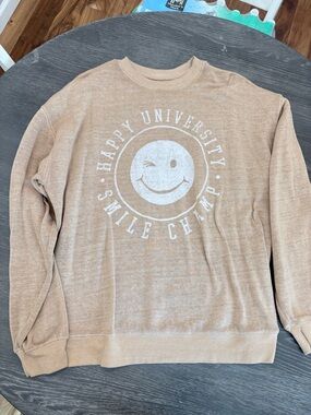 Woman’s  Tan Crewneck Sweatshirt with White Happy University Smile Graphic
